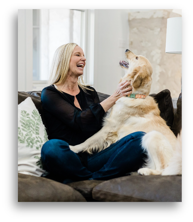 Dr. Kara Hartl playing with a dog