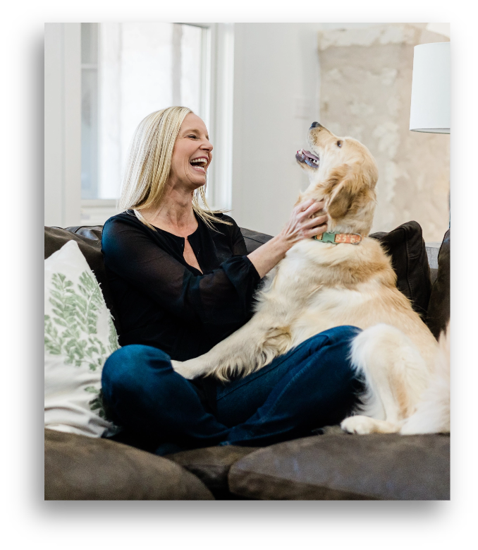 Who Is Dr. Kara Image Dr. Kara Hartl playing with a dog
